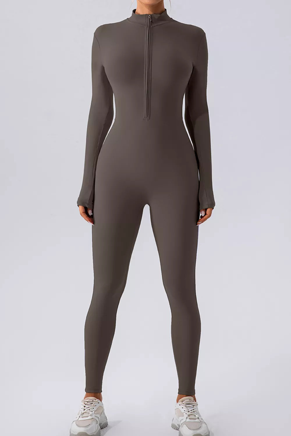 Chocolate brown active jumpsuit with mock neck half-zip front, long sleeves, slim fitted legs