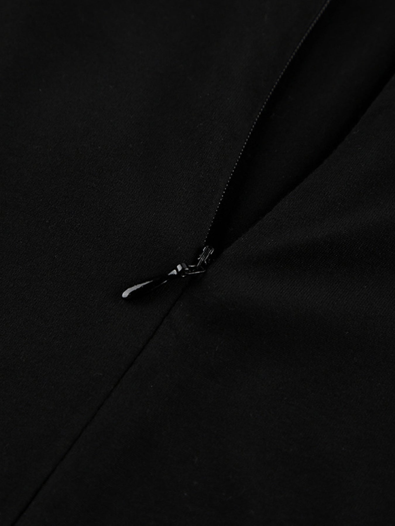 Black dress back zipper with small pull tab detail