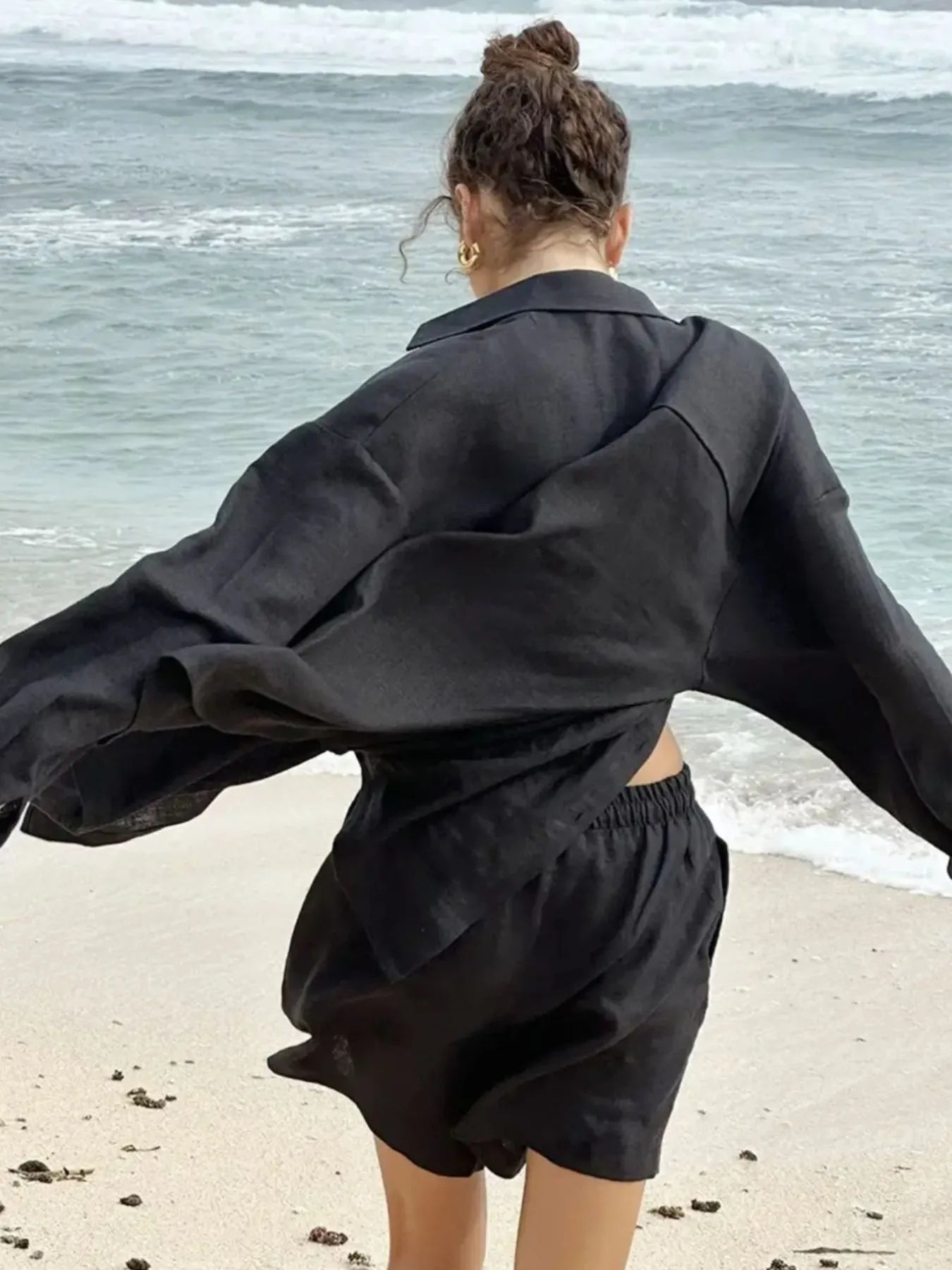 Black button-up long-sleeve shirt and matching elastic-waist shorts set, back view