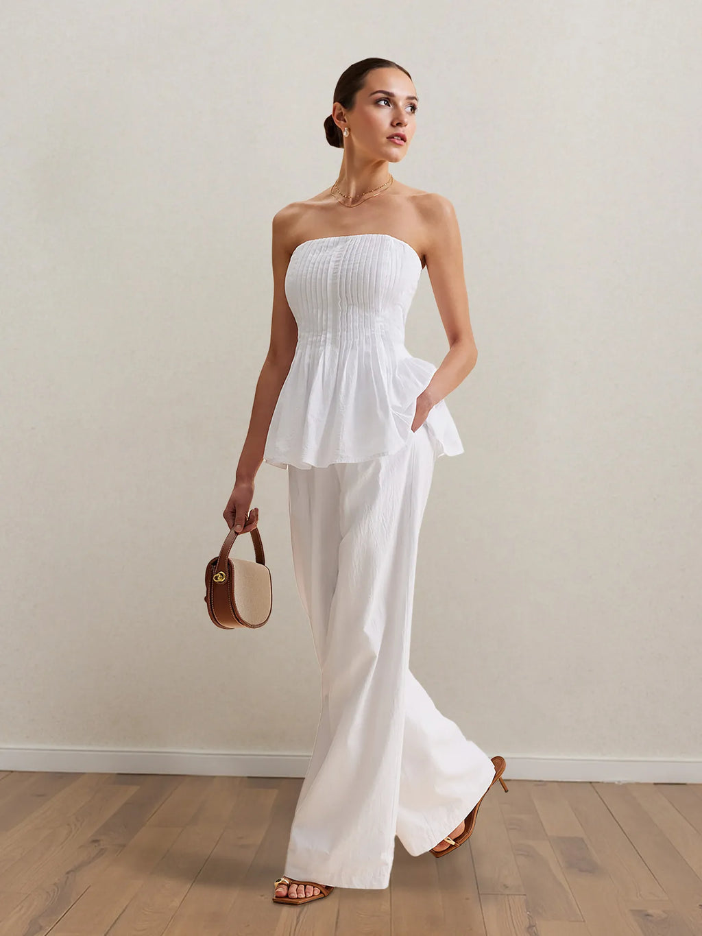 White strapless peplum top and wide-leg pants set, full body front view.