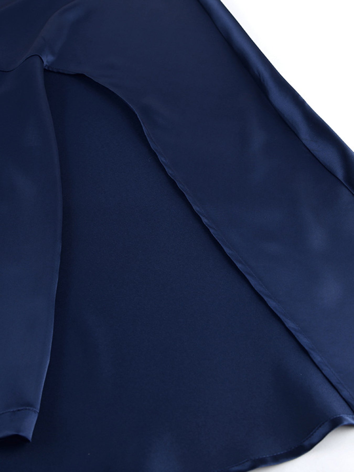 Navy cape sleeve mini dress close-up of skirt seam and draped sleeve panel