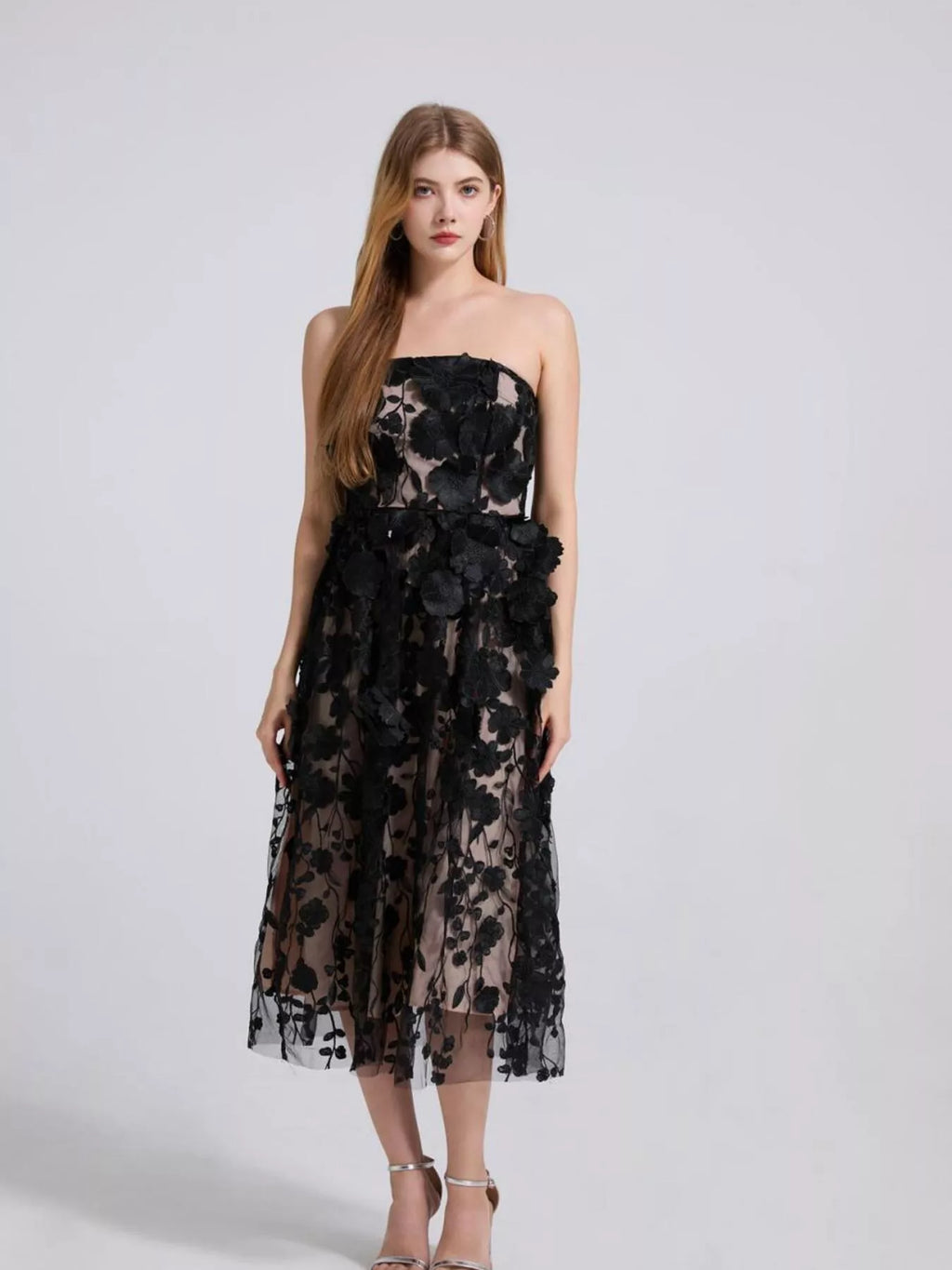 Black strapless midi dress featuring layered floral applique on a sheer skirt