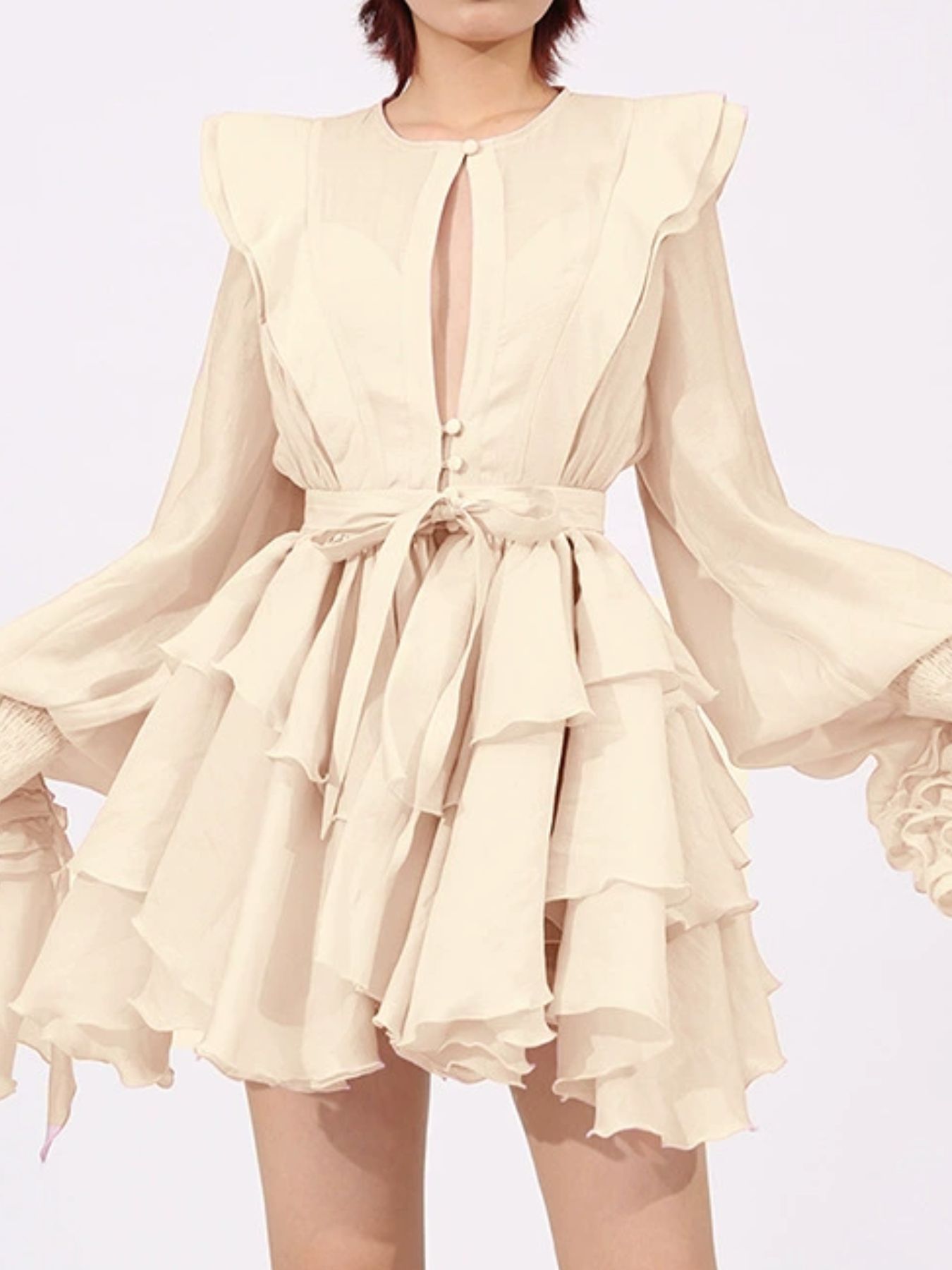 Apricot ruffled long-sleeve mini dress with layered skirt and neck buttons
