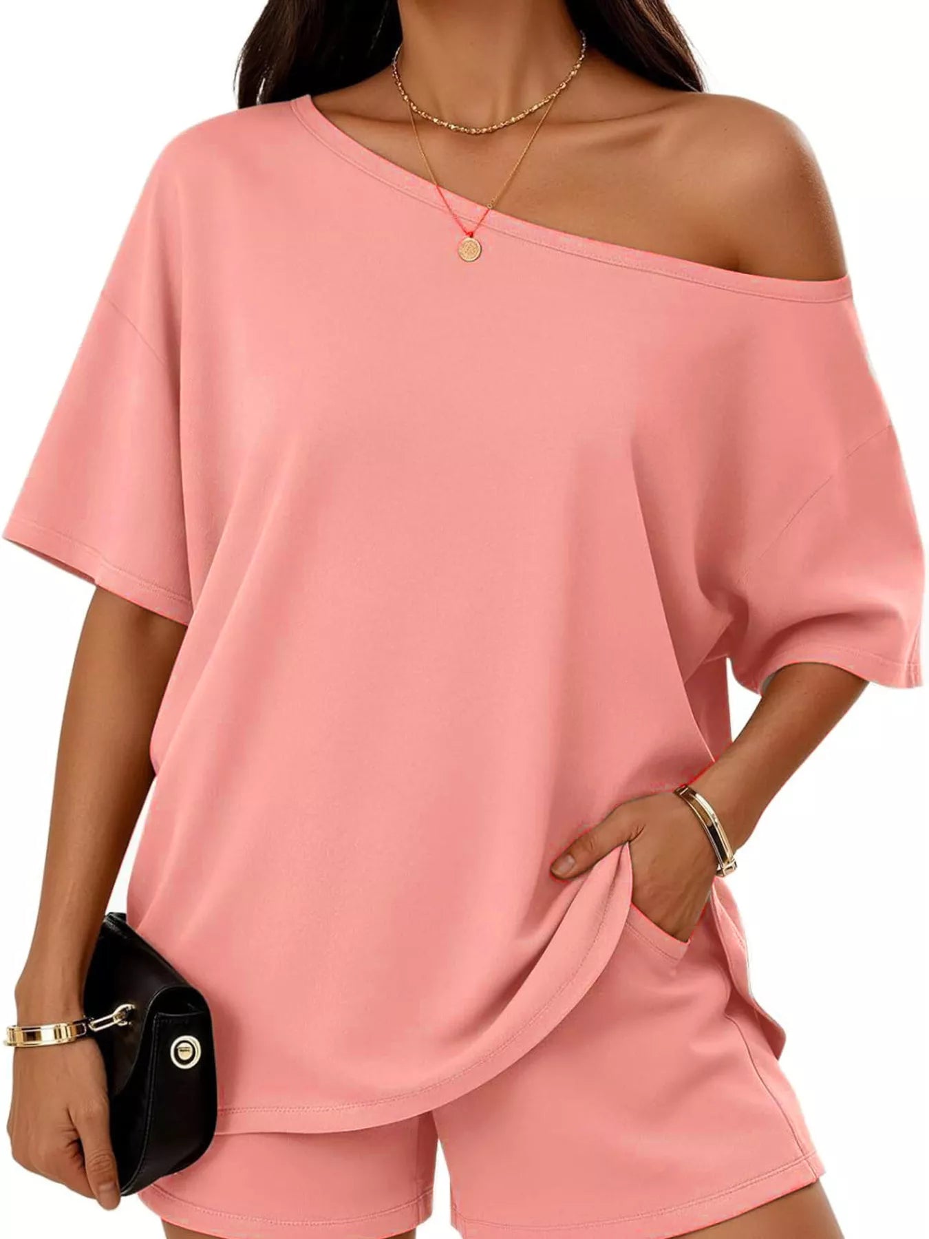 Peach pink one-shoulder top and matching shorts set with angled neckline, loose drape.