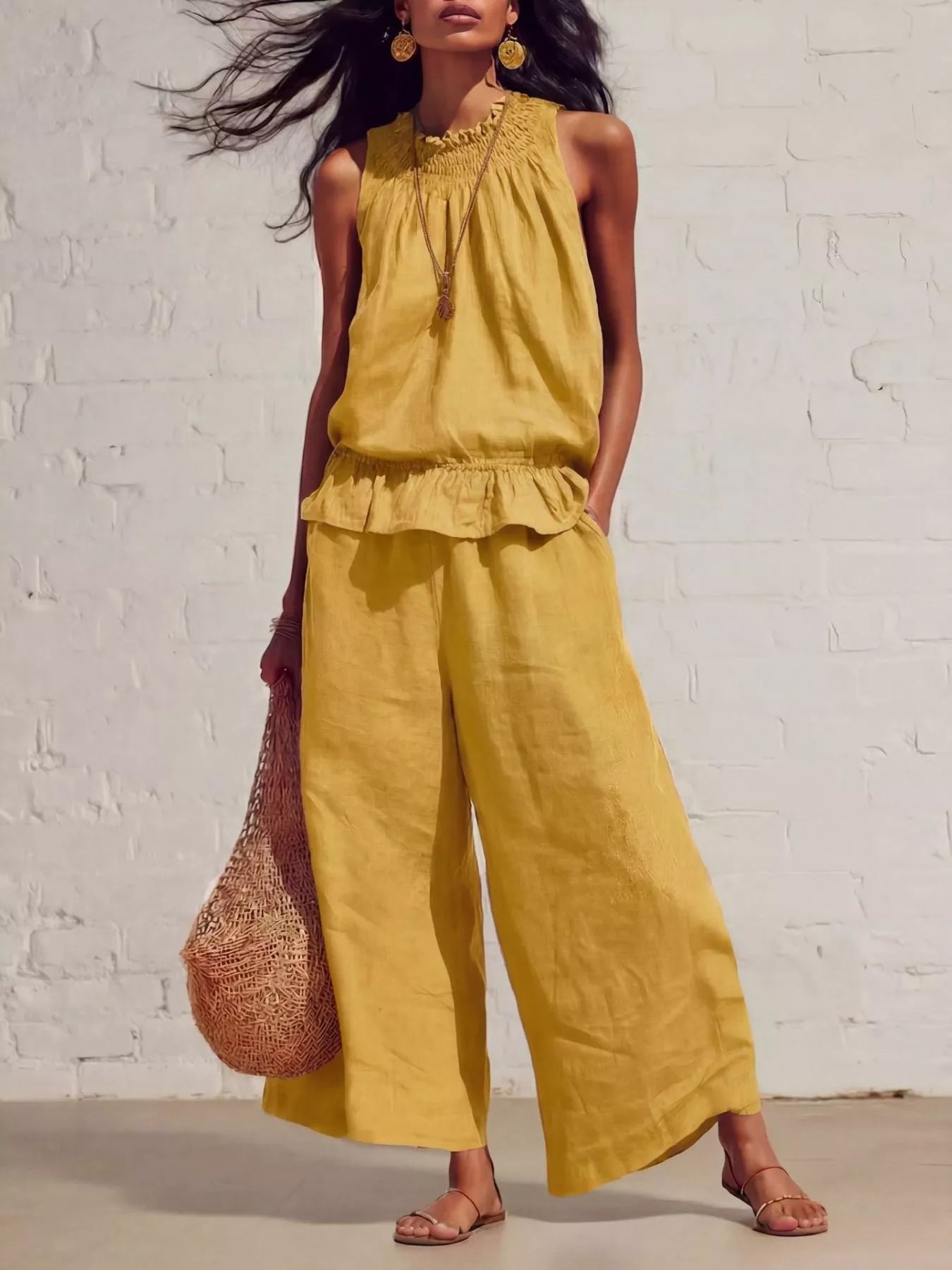 Yellow sleeveless smocked ruffled hem top and wide-leg pants set with tiered ruffle.