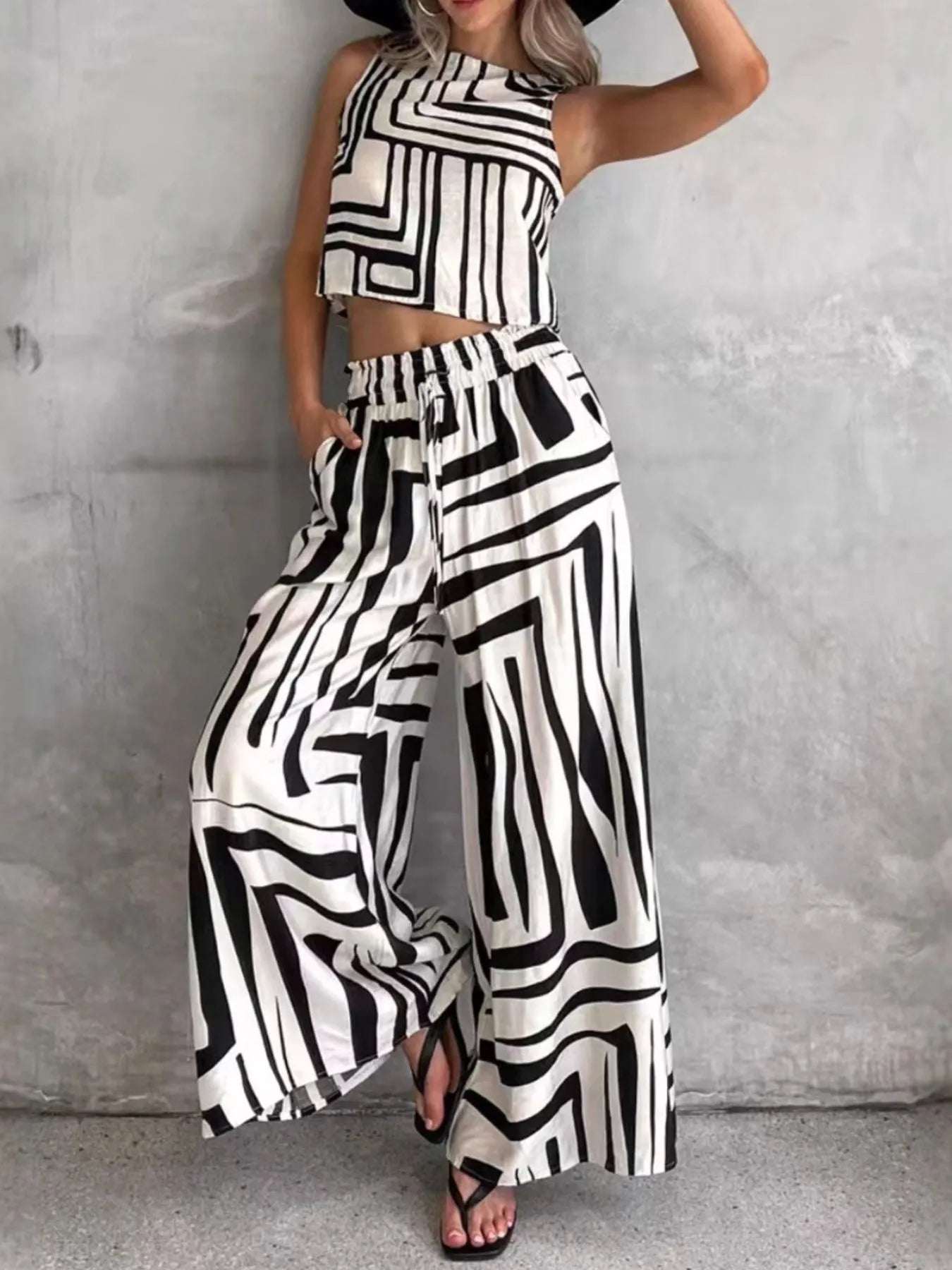 Sleeveless geometric print cropped top and wide-leg pants set in black-and-white.
