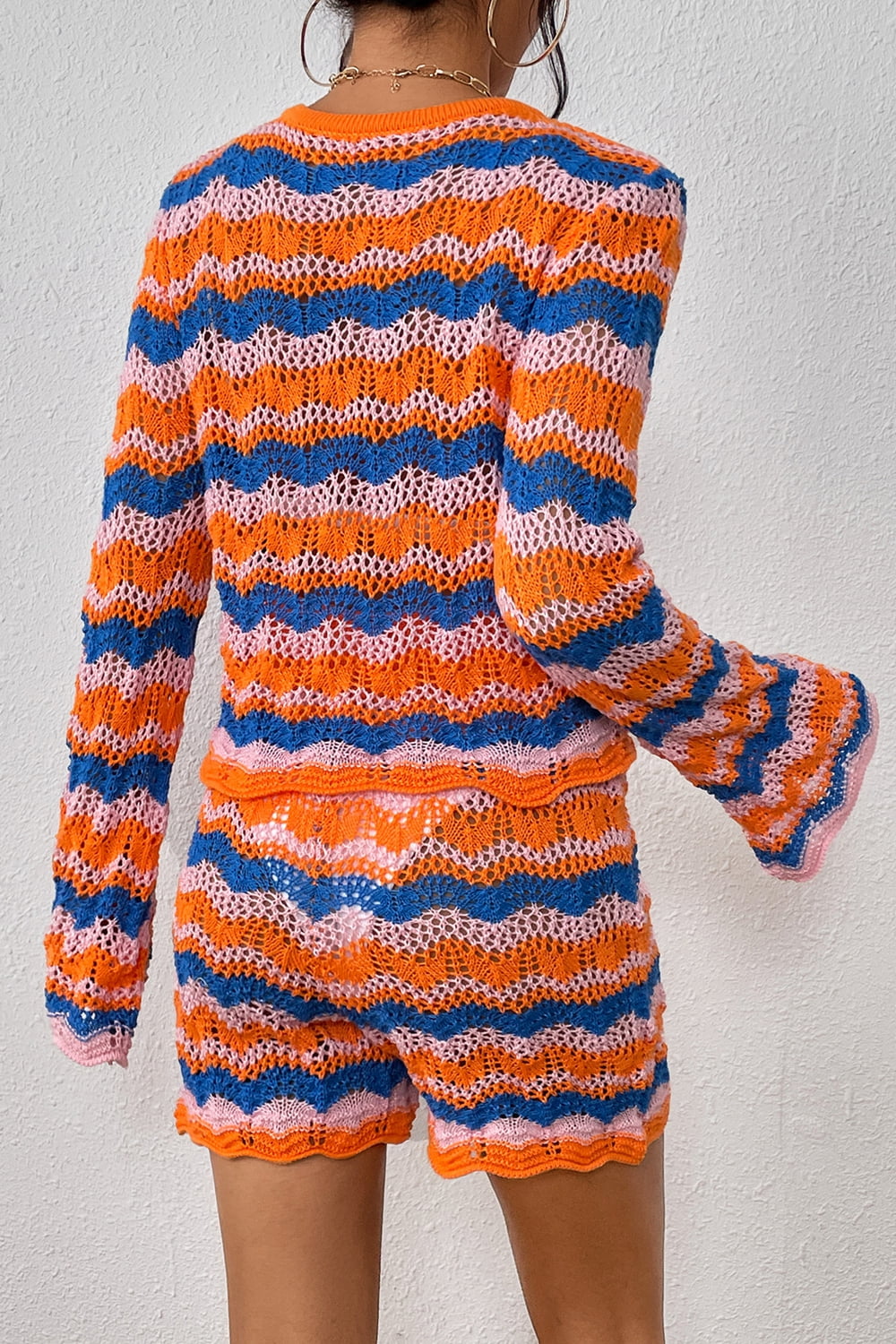 Striped knit sweater and shorts set with orange-red and blue wavy stripes, crew neck.