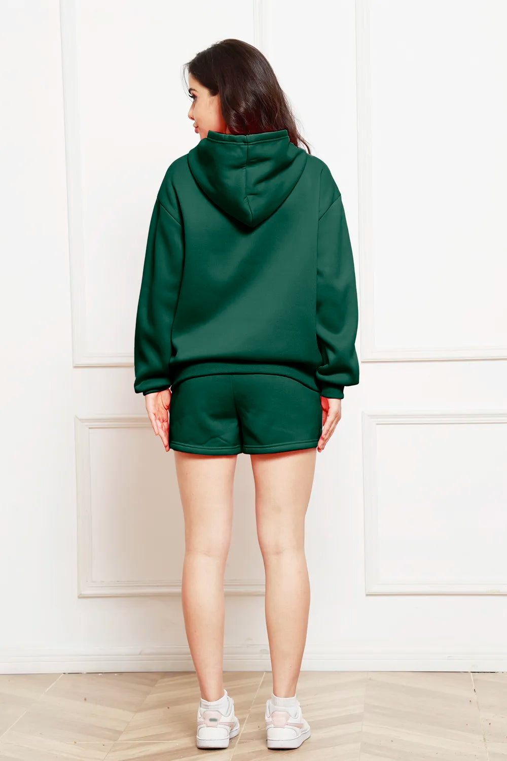 Dark green drop-shoulder hoodie and shorts set, back view with hood.