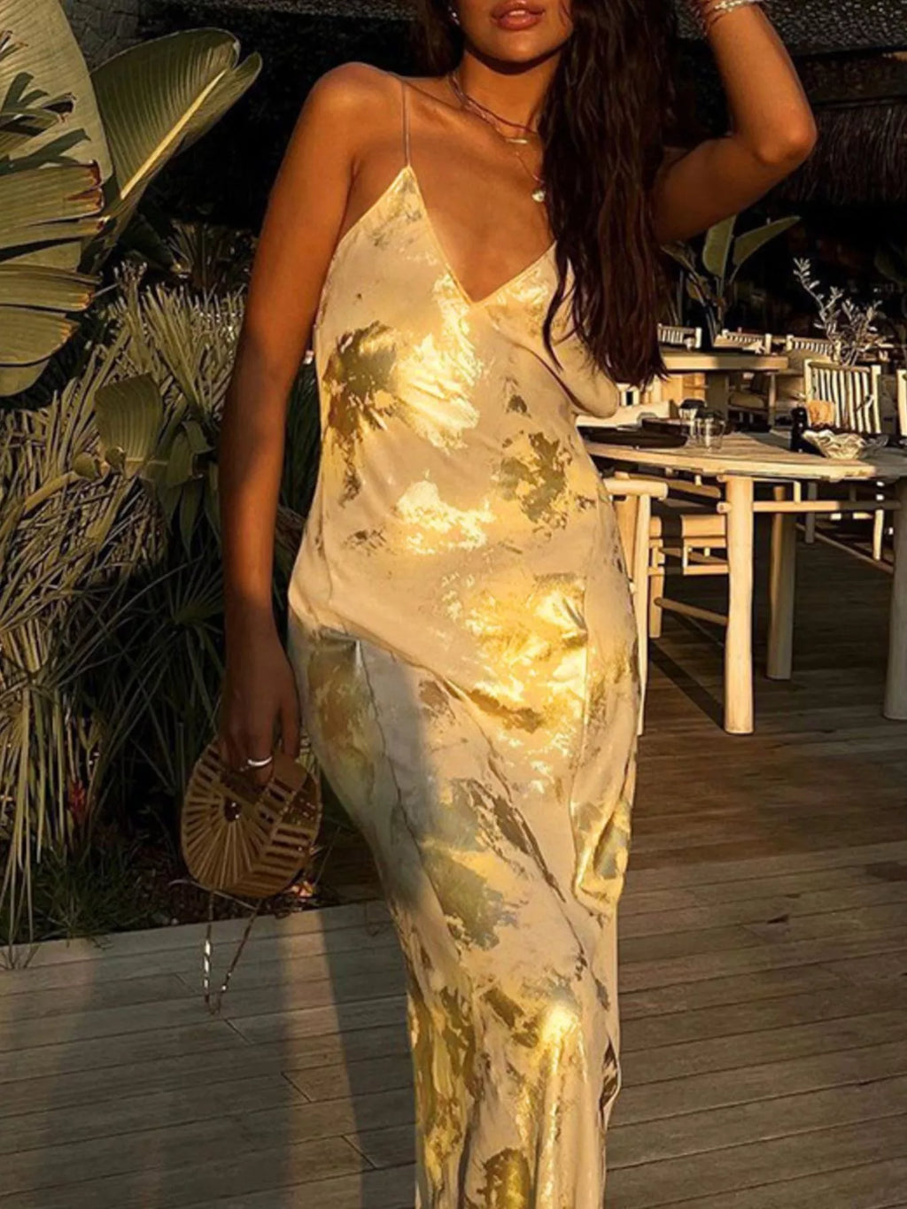 Gold backless V-neck maxi dress with spaghetti straps and fitted, floor-length cut