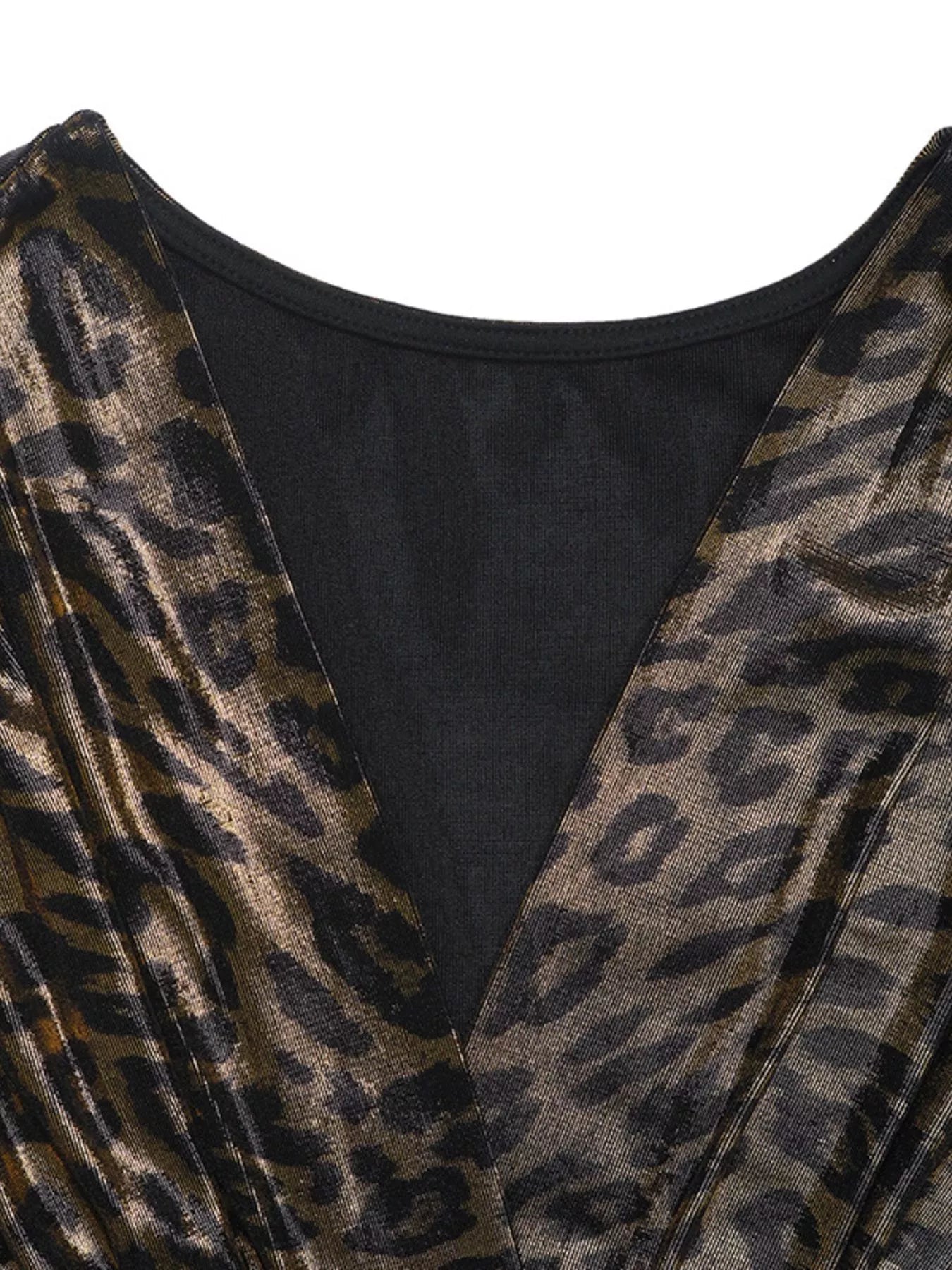 Close-up of black surplice V-neck with metallic leopard-print sleeve fabric panel