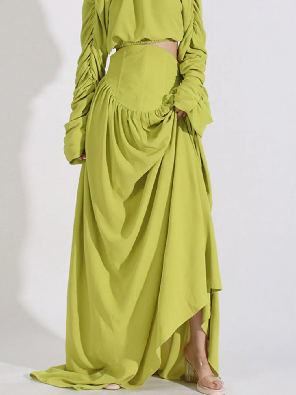Green ruched long-sleeve crop top and high-waist maxi skirt with draped side