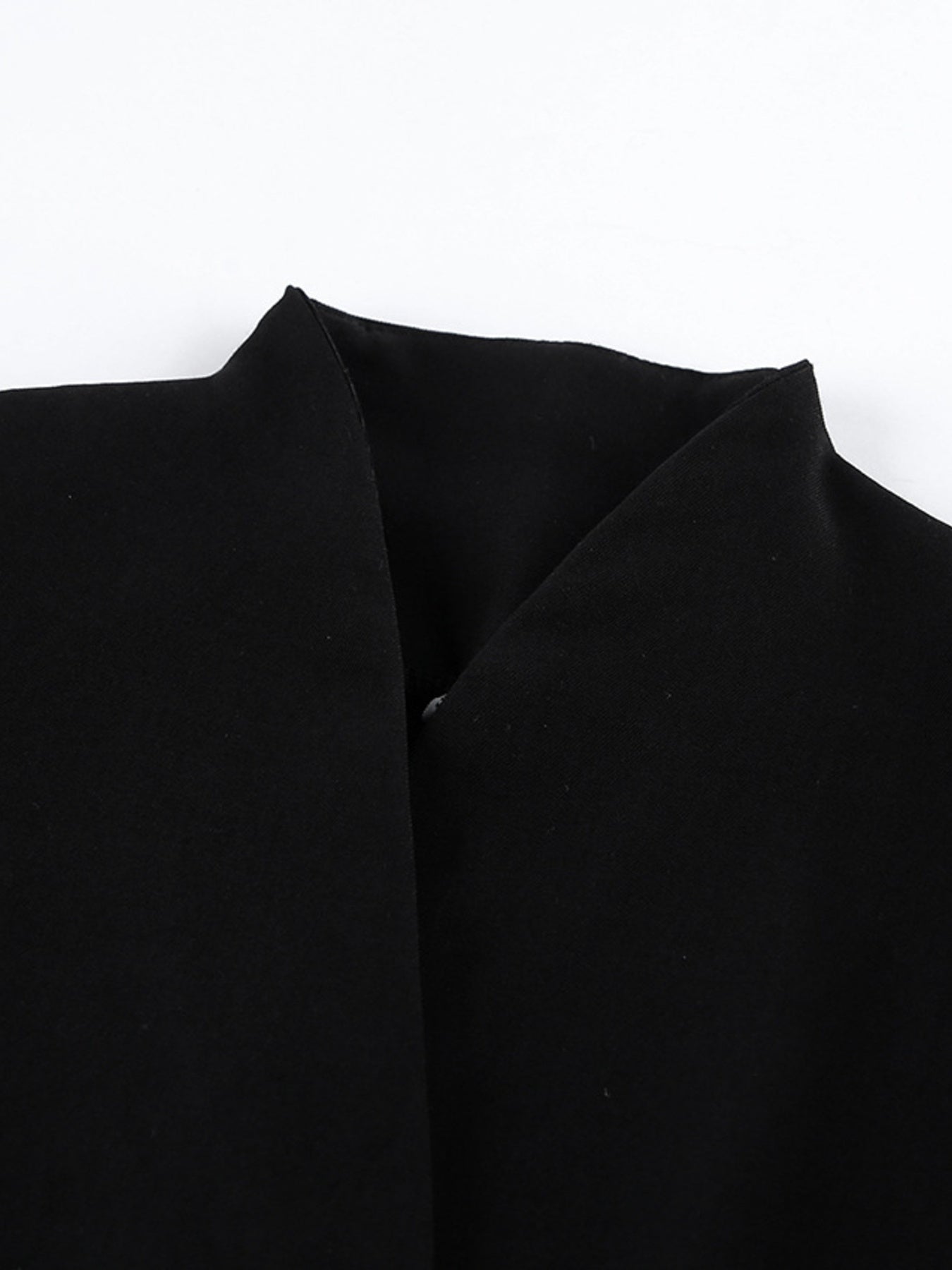 Black blazer dress lapel area with structured shoulder and seam lines