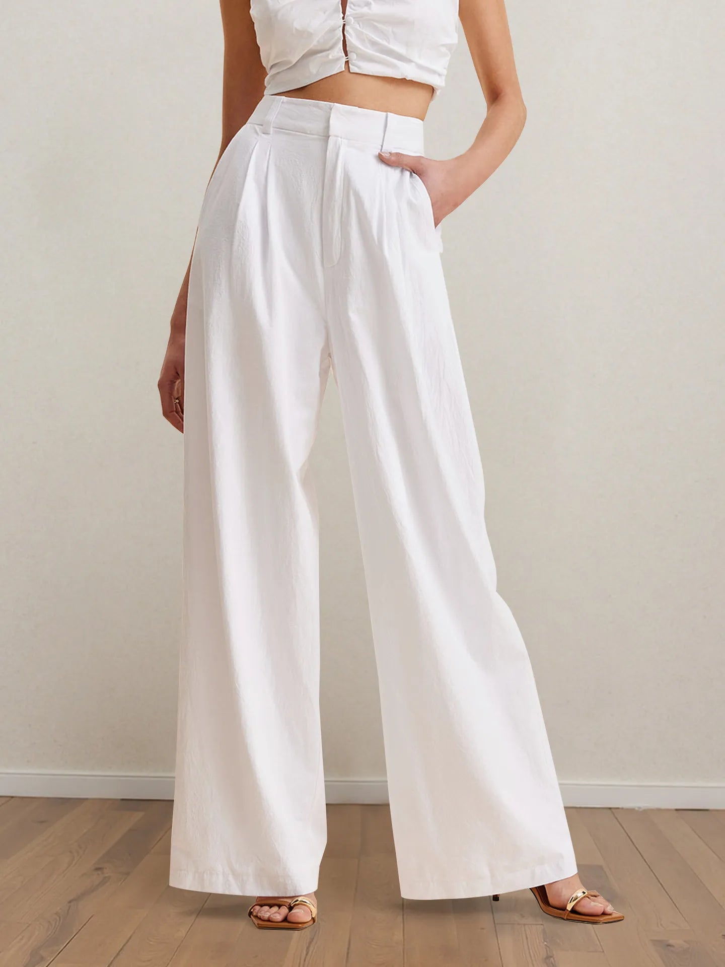 White wide-leg pants with high waist and matching strapless peplum top, side view.