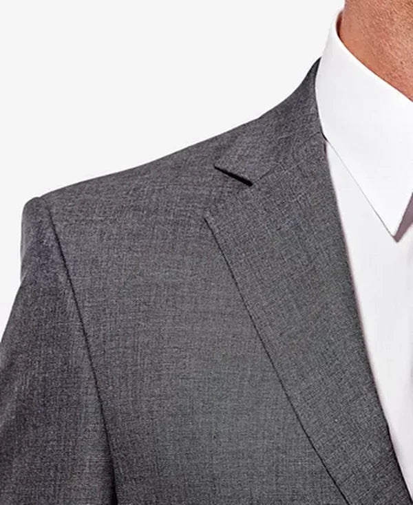Dark gray suit jacket lapel and shoulder with subtle textured weave